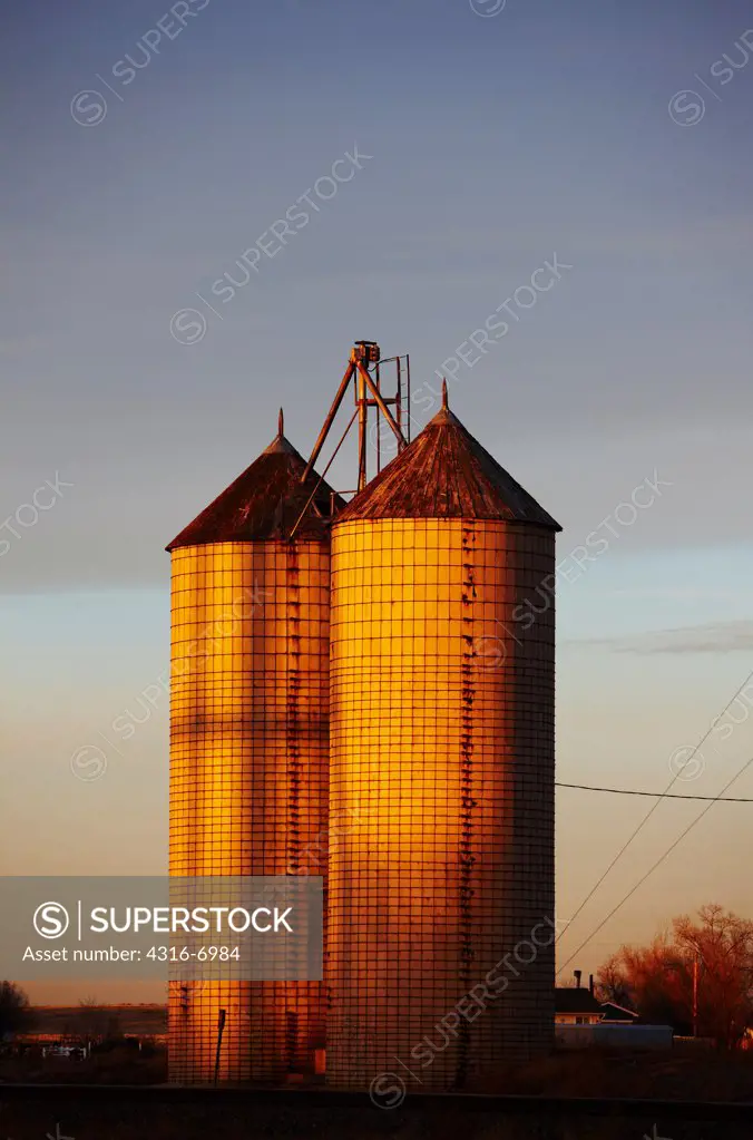 USA, Colorado, Grain elevators at sunset