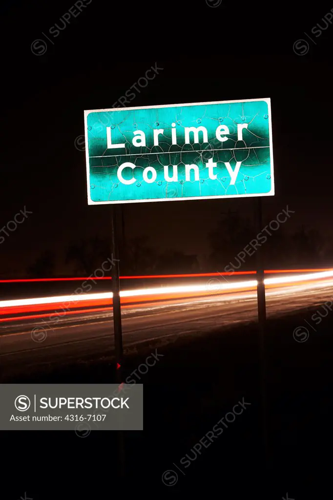 Larimer County sign on Colorado State Highway 14 at night, Colorado, USA