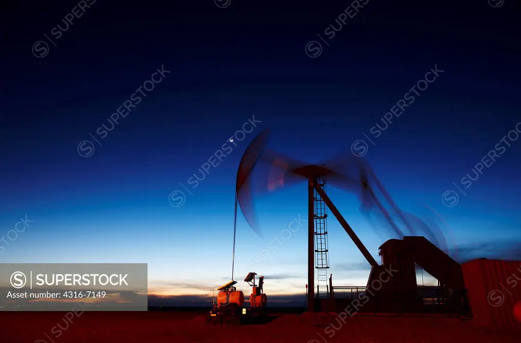 USA, Colorado, Oil well pumpjack (pump jack), crescent moon. Oil well developed with hydraulic fracturing, also known as hydrofracking or fracking