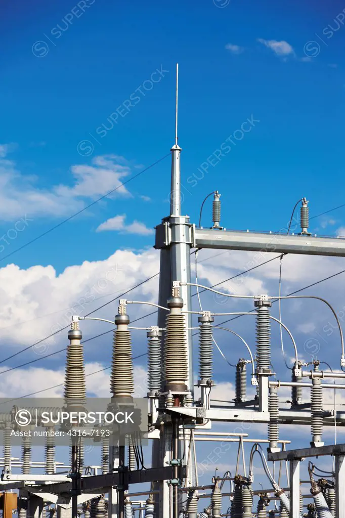 Detail of components of electricity substation, Showing high voltage power lines, insulators on transformer assembly, And lightning arresters
