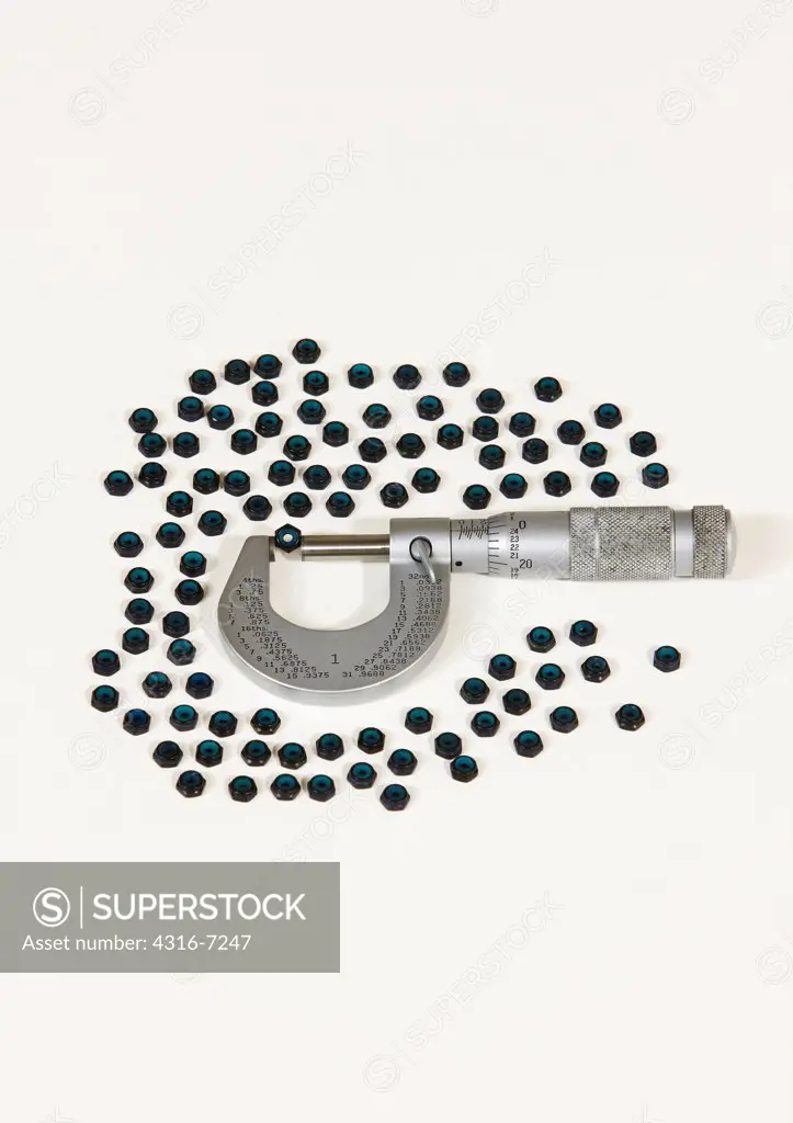 Black anodized nylon locking nuts, known as nylocs, or nyloc insert lock nuts, with caliper micrometer