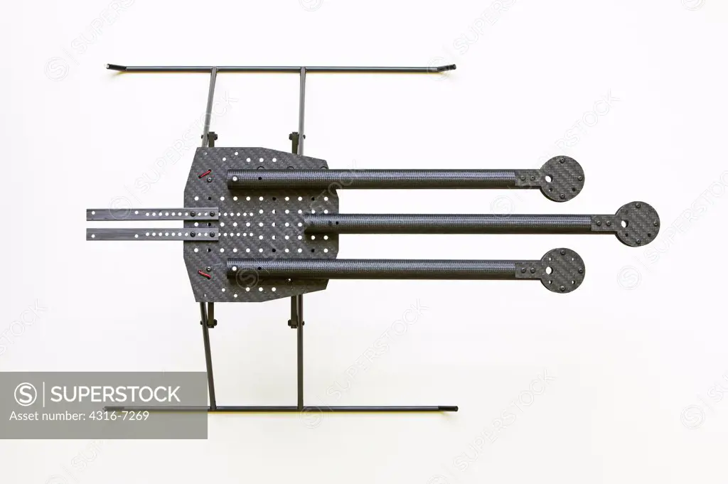 Partially constructed prototype experimental unmanned aerial vehicle (UAV), composed of carbon fiber parts precision milled by computer numerical controlled (CNC) milling machine, showing folded configuration of body