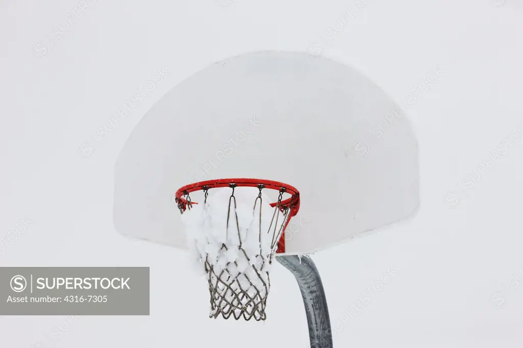 USA, Colorado, Basketball hoop filled with wet, heavy snow from spring snowstorm