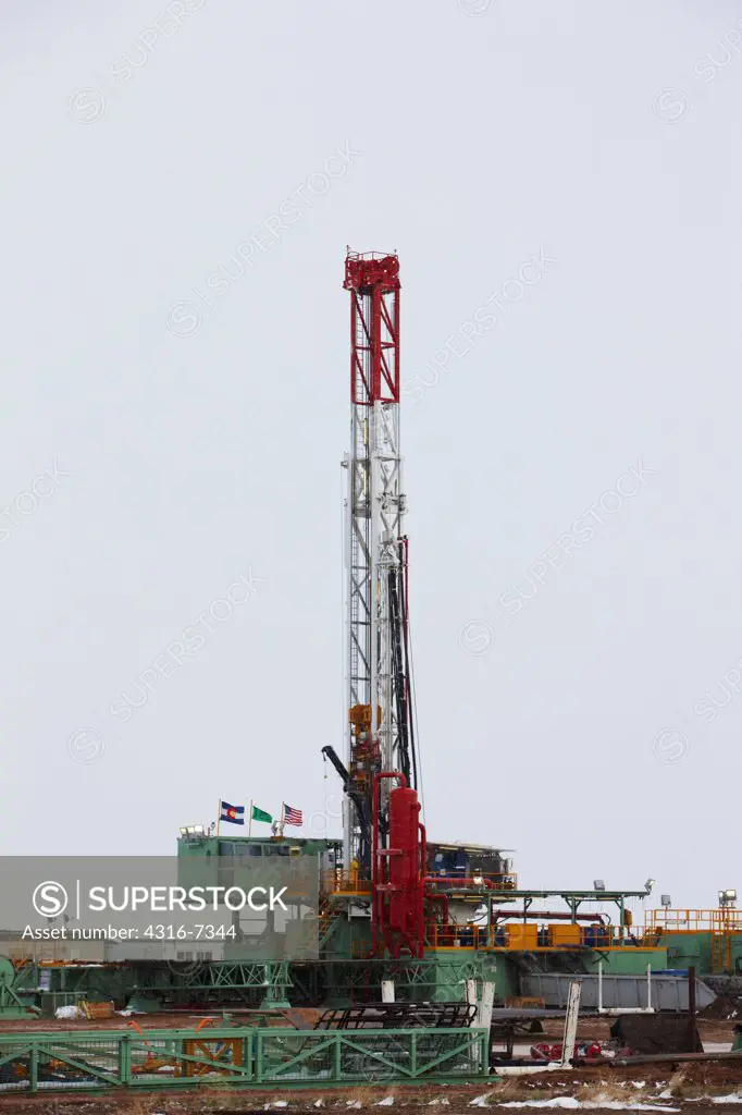 USA, Colorado, Eastern Plains of Colorado, Oil well pump drilling rig, using hydraulic fracturing (called fracking or hydrofracking) during blizzard