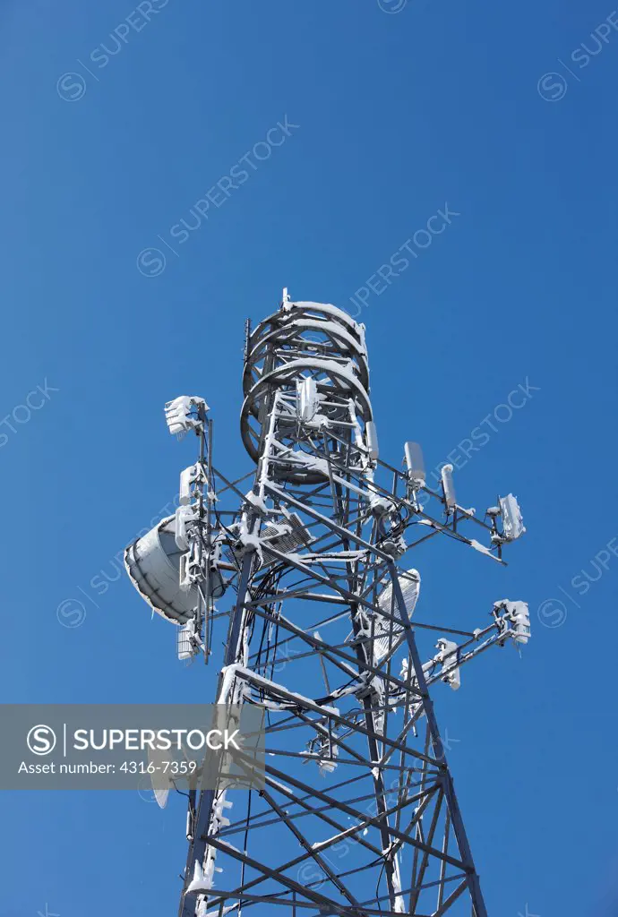 USA, Colorado, Microwave relay tower with wet, heavy snow after blizzard