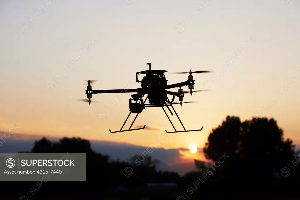 Unmanned Aerial Vehicle (UAV), also called drone, in flight, silhouette
