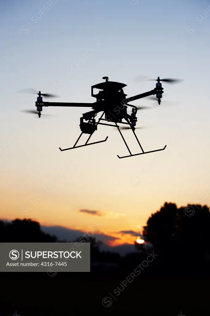 Unmanned Aerial Vehicle (UAV), also called drone, in flight, silhouette