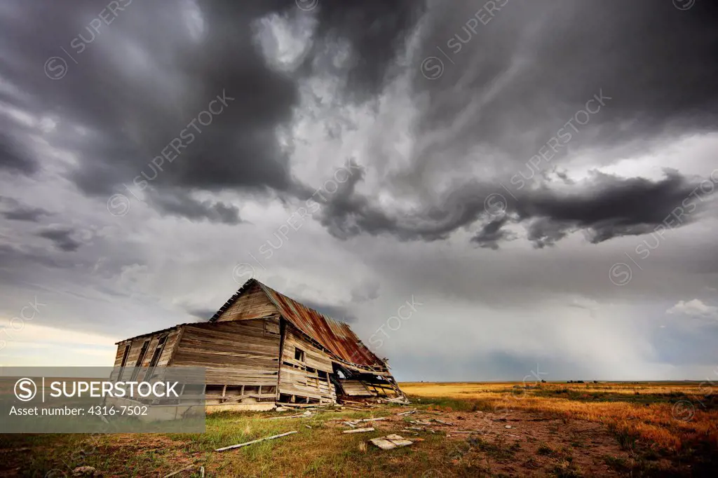 Abandoned, decaying barn, approaching powerful thunderstorm that spawned a funnel cloud, Colorado