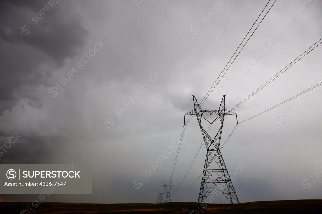 Electricity transmission towers and high voltage power lines during a powerful thunderstorm that spawned a funnel cloud, Colorado