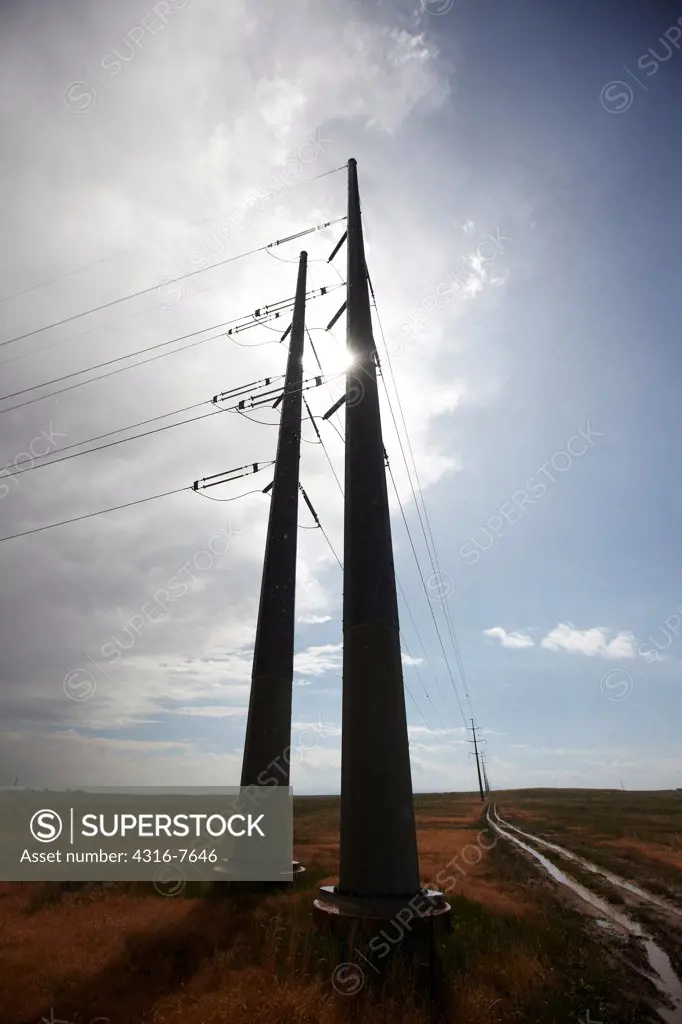 Silhouette of high voltage power lines and two transmission towers, Colorado