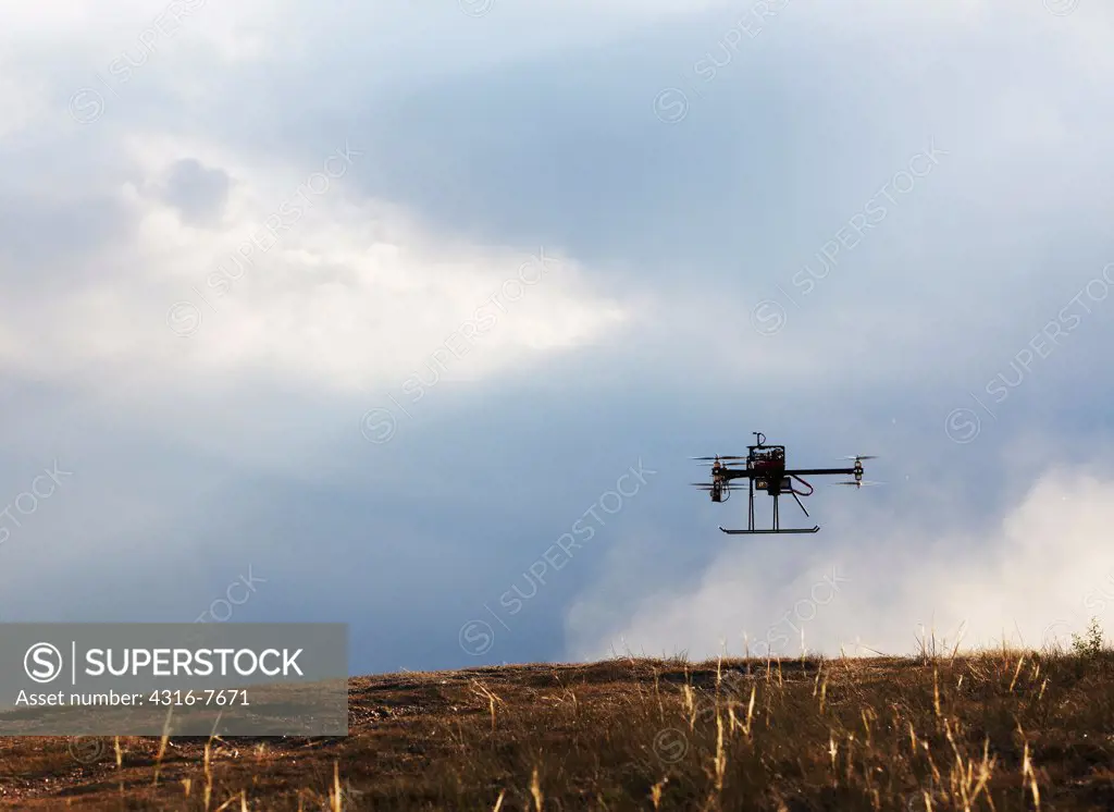 Unmanned aerial vehicle (UAV) or drone, Lifting off from ground in cloud of dust