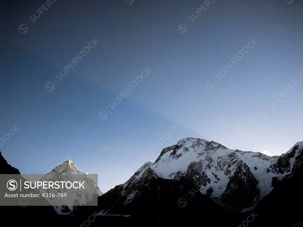 The Rising Sun Creates a Ramp of Light Over Broad Peak and K2