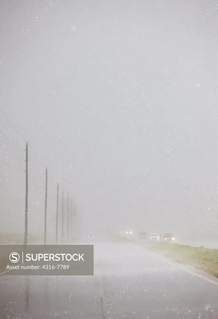 Interstate highway and frontage road during a dangerous thunderstorm dropping hail, Colorado, USA