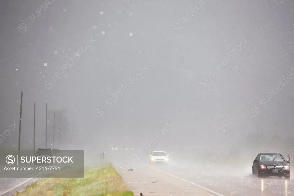 Interstate highway and frontage road during a dangerous thunderstorm dropping hail, Colorado, USA