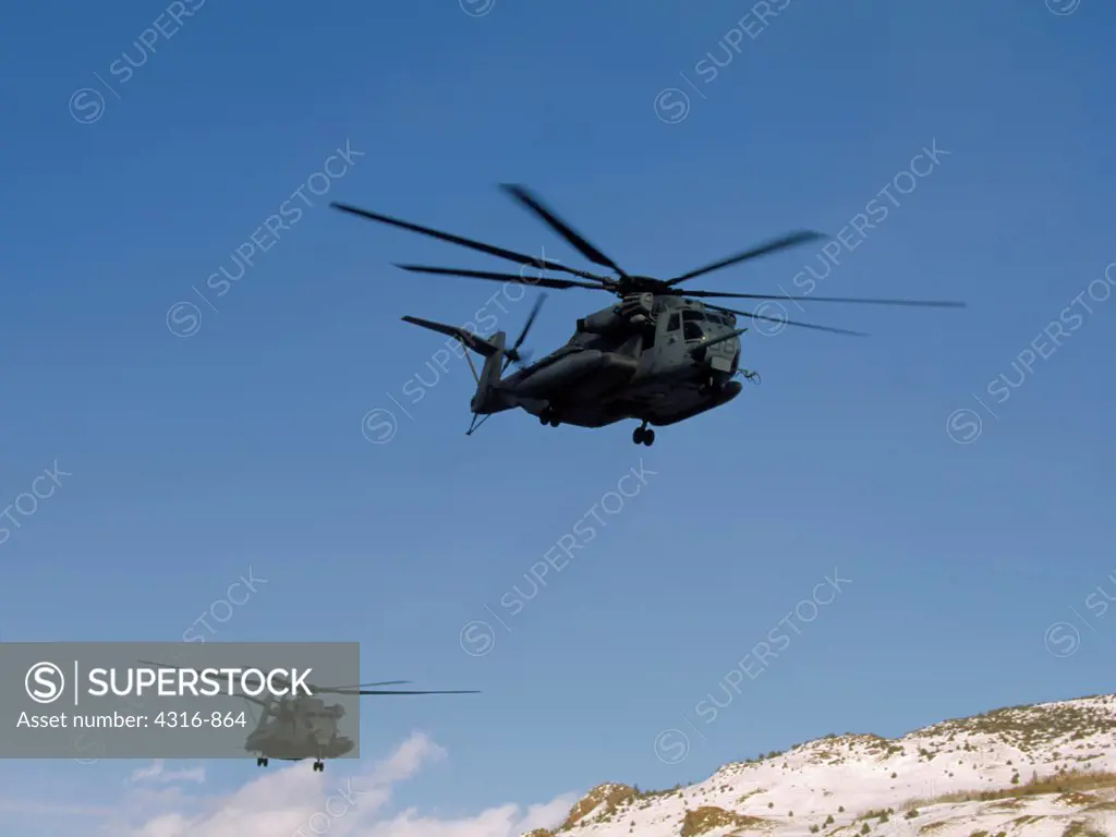 Two US Marine Corps CH-53E Super Stallion Helicopters Roar into the Cold Heights