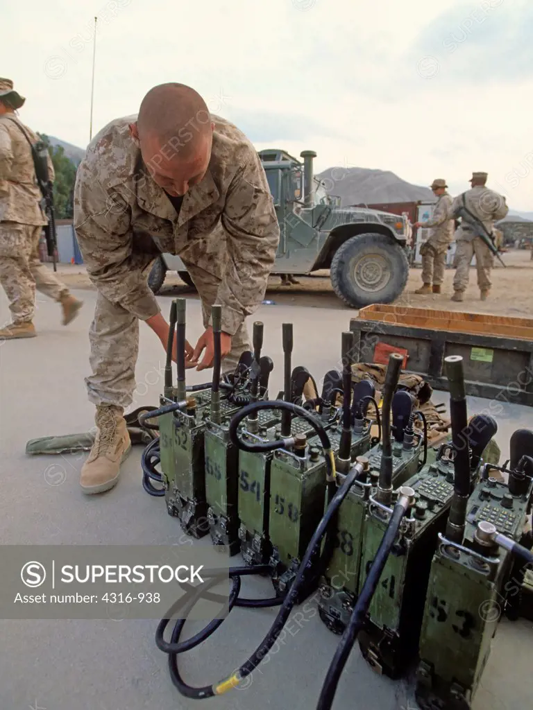 A US Marine Prepares Radios for an Upcoming Combat Operation in Afghanistan's Eastern Kunar Province