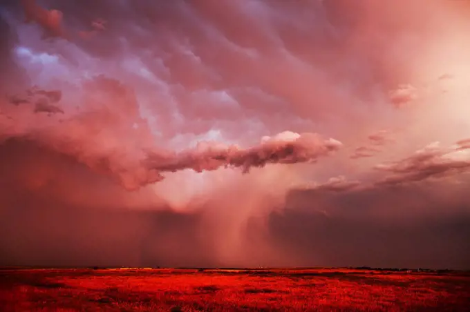 Sunset light on a powerful thunderstorm dropping dense rain over the eastern plains of Colorado