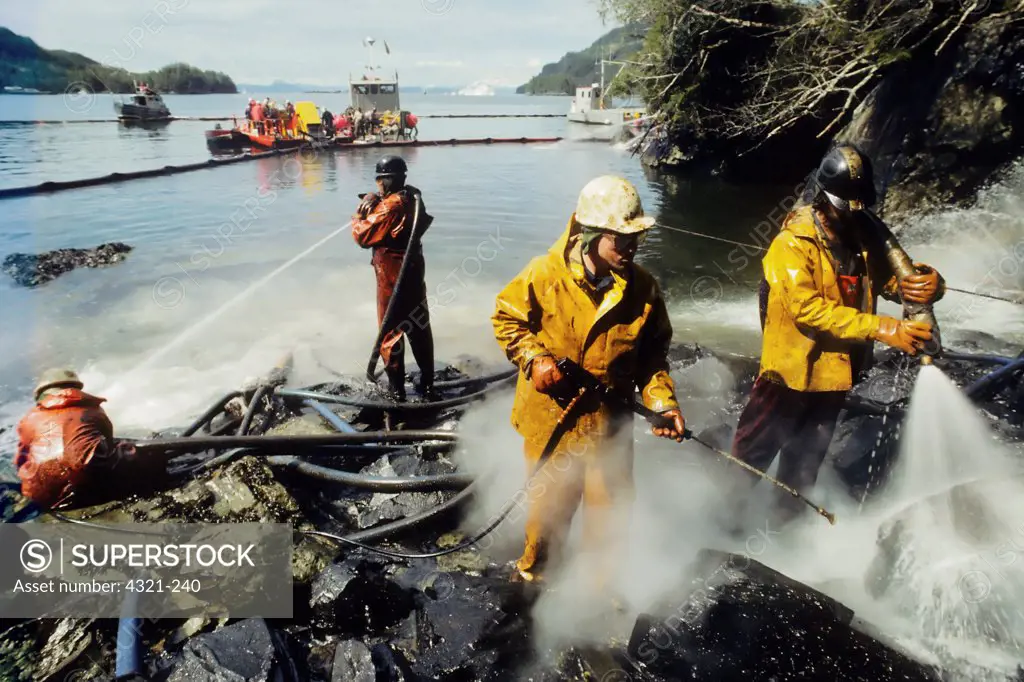 Workers Spray Oil From the Rocky Coast