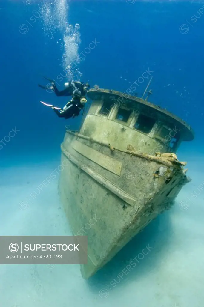 A Pair of Scuba Divers Approach the Captain Fox Tugboat Wreck