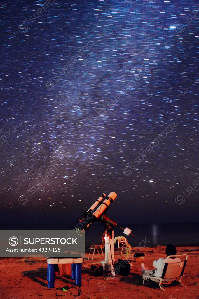 Relaxing on the beach in the Florida Keys, Bill Williams enjoys the starry sky while his computer driven telescope records the Orion Nebula. Over the last ten years CCD cameras have largely replaced imaging with film