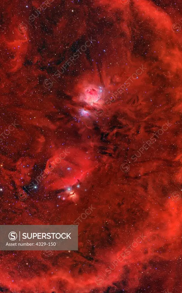 The maze of dust particles surrounding the familiar Horsehead (lower) and Orion Nebulas. The arcing bright nebulosity to the right is portions of Bernard's Loop.