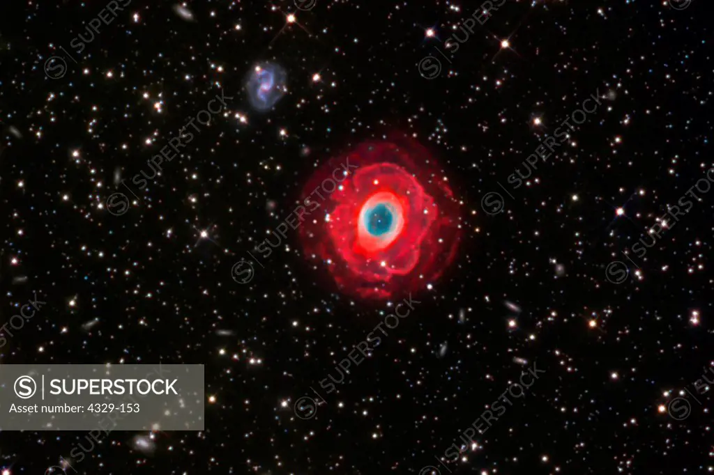 In the constellation Lyra, the Ring Nebula lies 2000 light years from Earth. A very deep image with the nebula surrounded by faintly glowing HII regions. Also visible is the faint galaxy IC 1296; the depth shows the color of the galaxy and that it is surrounded by a ring of its own.