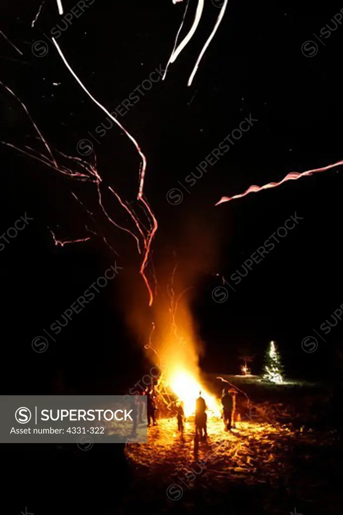 USA, New Hampshire, Tamworth, Group of people around large campfire