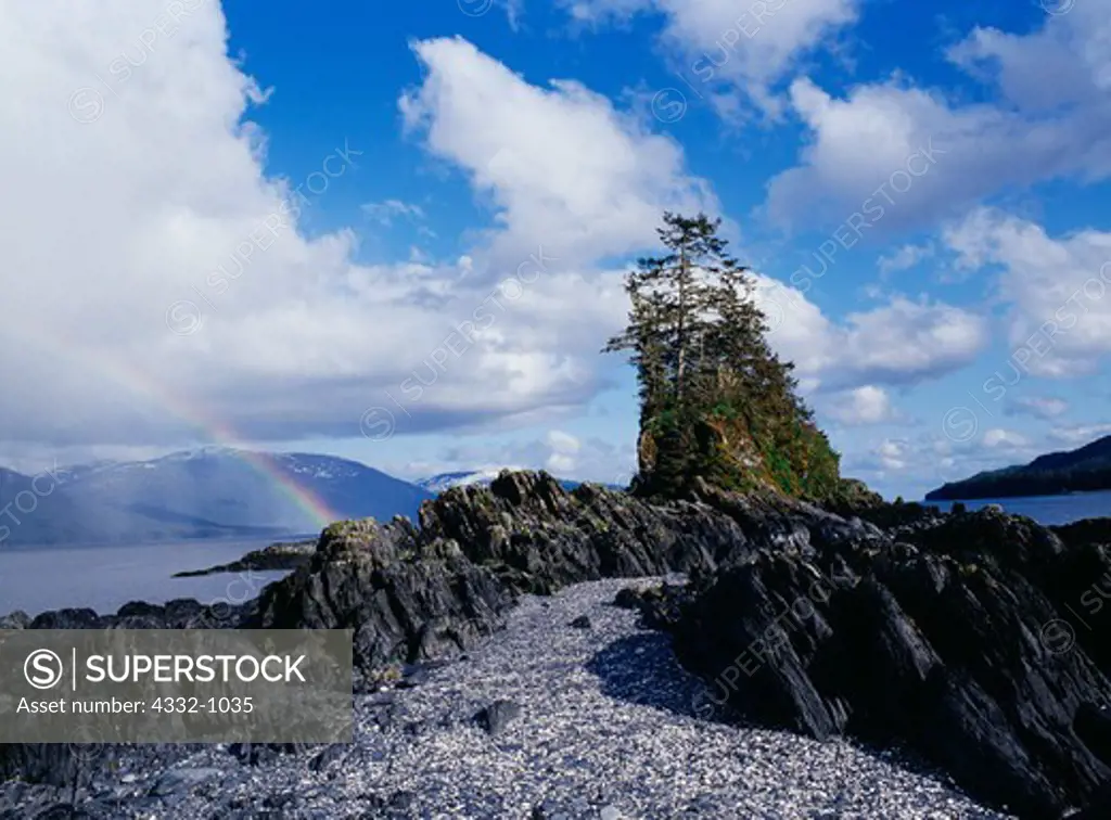 Rainbow beyond shale outcrop on Tiedeman Island, Seymour Canal, Admiralty Island Wilderness, Admiralty Island National Monument, Tongass National Forest, Alaska.