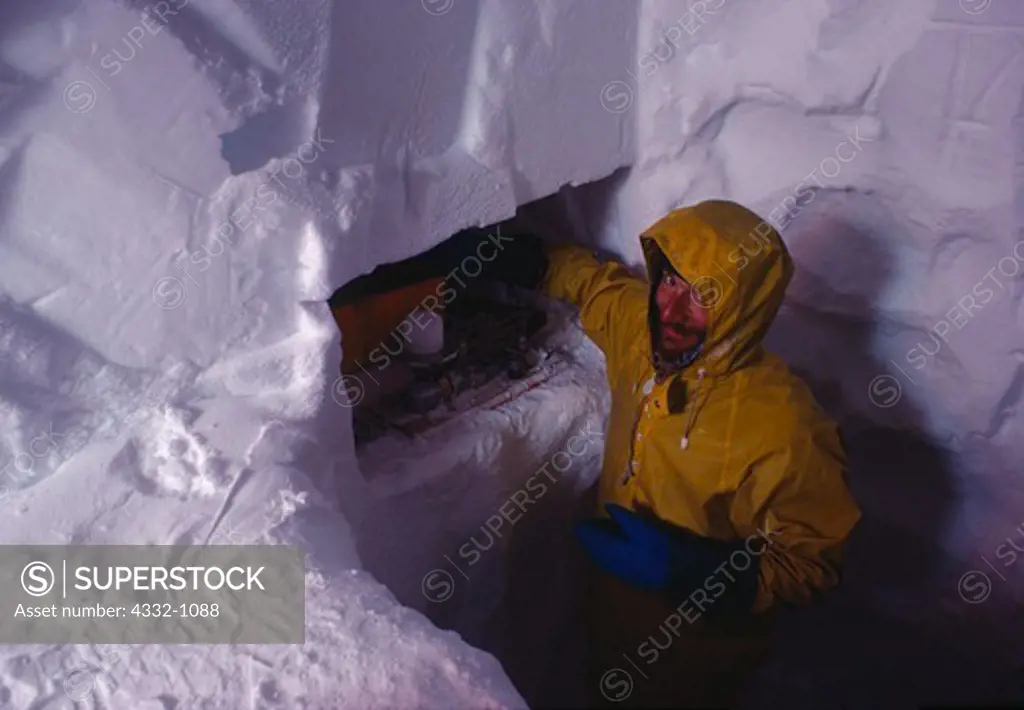 Glaciologist Matthew Sturm of the Alaska Geophysical Institute weighing ice core sample from Mount Redoubt summit crater glacier, Lake Clark National Park, Alaska.