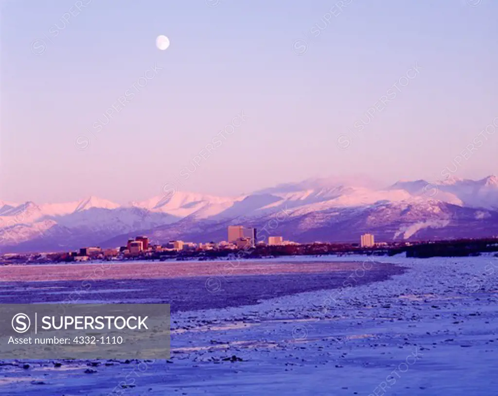 Winter moonrise over Anchorage.  View from Earthquake Park on the Knik Arm of Cook Inlet, Anchorage and the Chugach Mountains, Alaska.