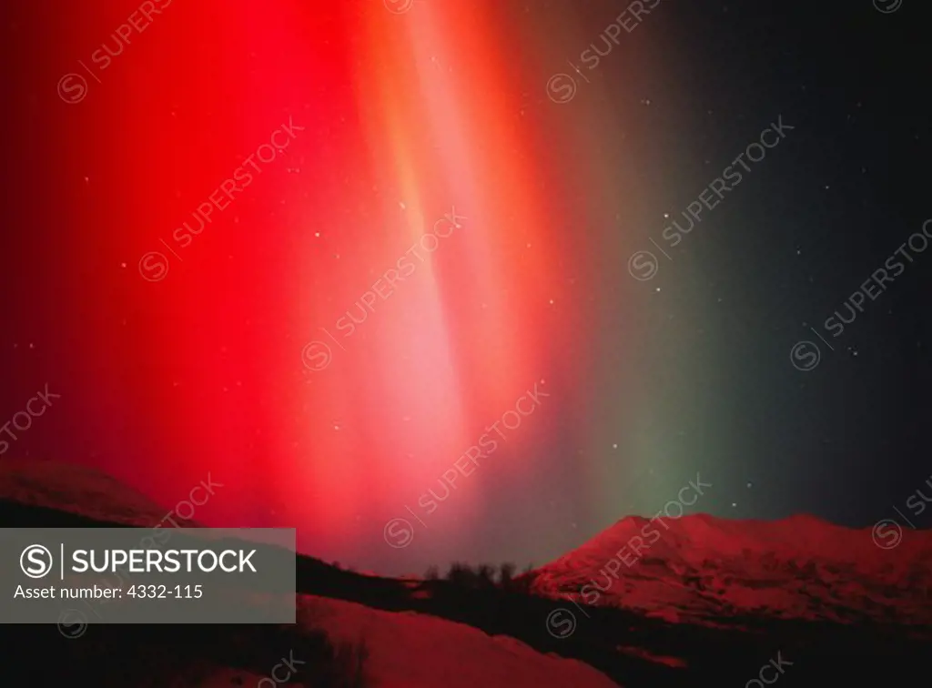 Red and green auroral colors produced when charged solar particles strike single atoms of oxygen at altitudes between 60 and 600 miles. This display of Northern Lights occurred during a geomagnetic storm in the early evening hours of November 5, 2001.