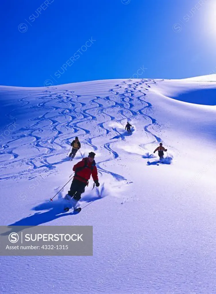 Chugach Powder Guides Heli-skiers enjoying fresh powder on the Skookum Run, Kenai Mountains, Chugach National Forest, Alaska.