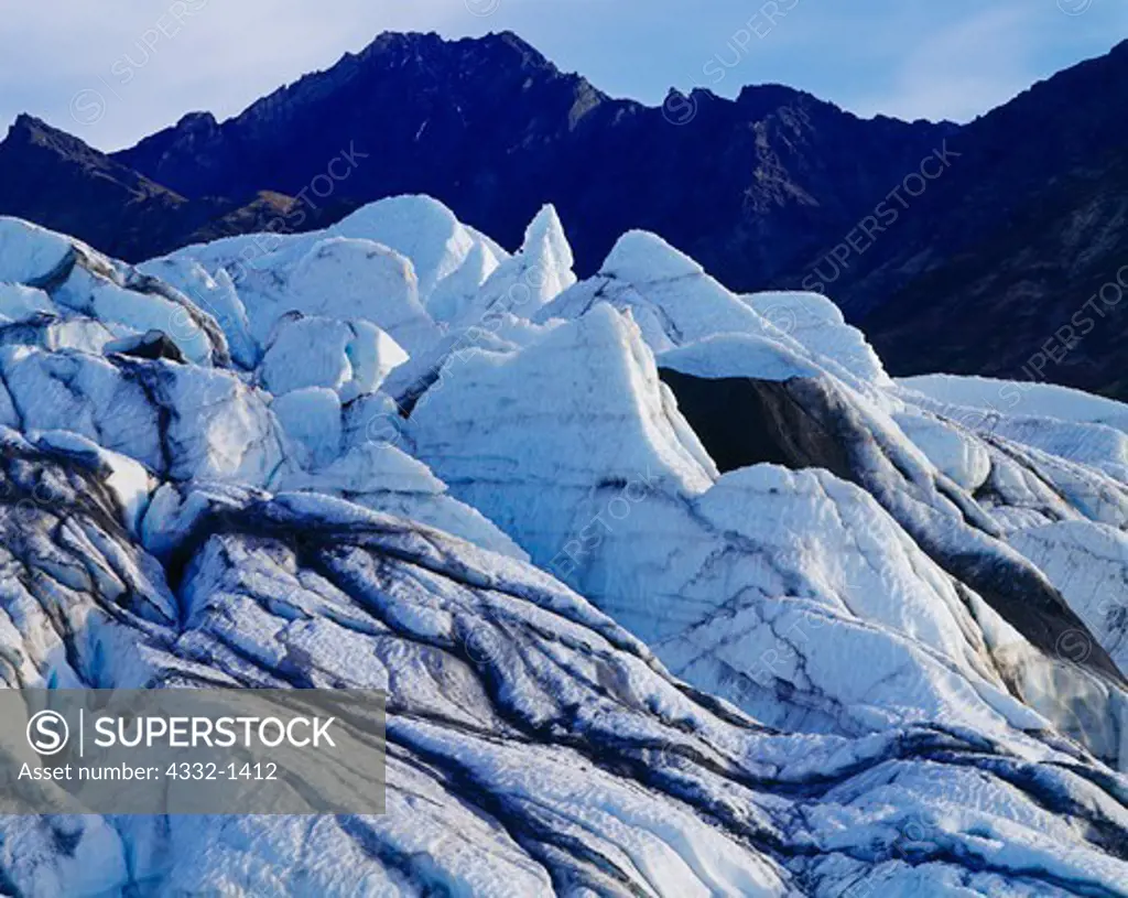 The Matanuska Glacier flowing from the Chugach Mountains with Mount Wickersham beyond, Alaska.