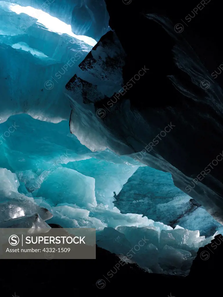 Large Ice Cave within 'Moulin Glacier' with ice boulders on floor from earlier ceiling collapse, Chugach Mountains, Alaska.