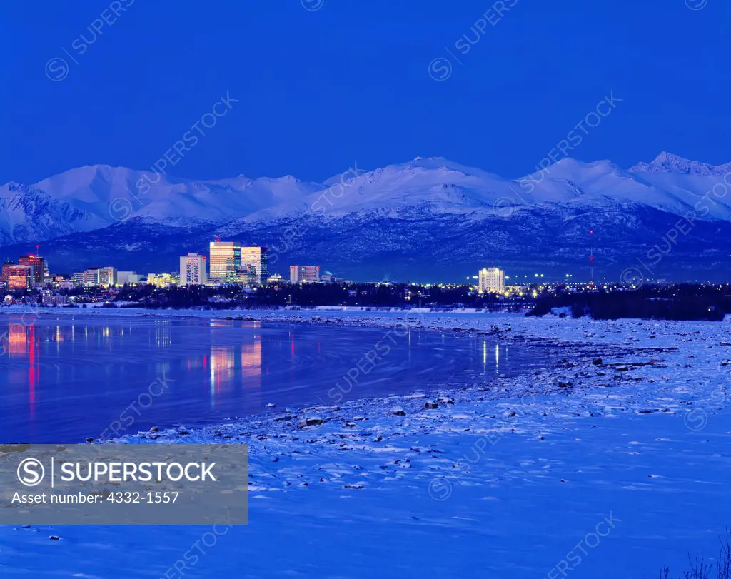Winter view of the skyline of Anchorage at dusk reflecting in Cook Inlet, Earthquake Park, Anchorage, Alaska.
