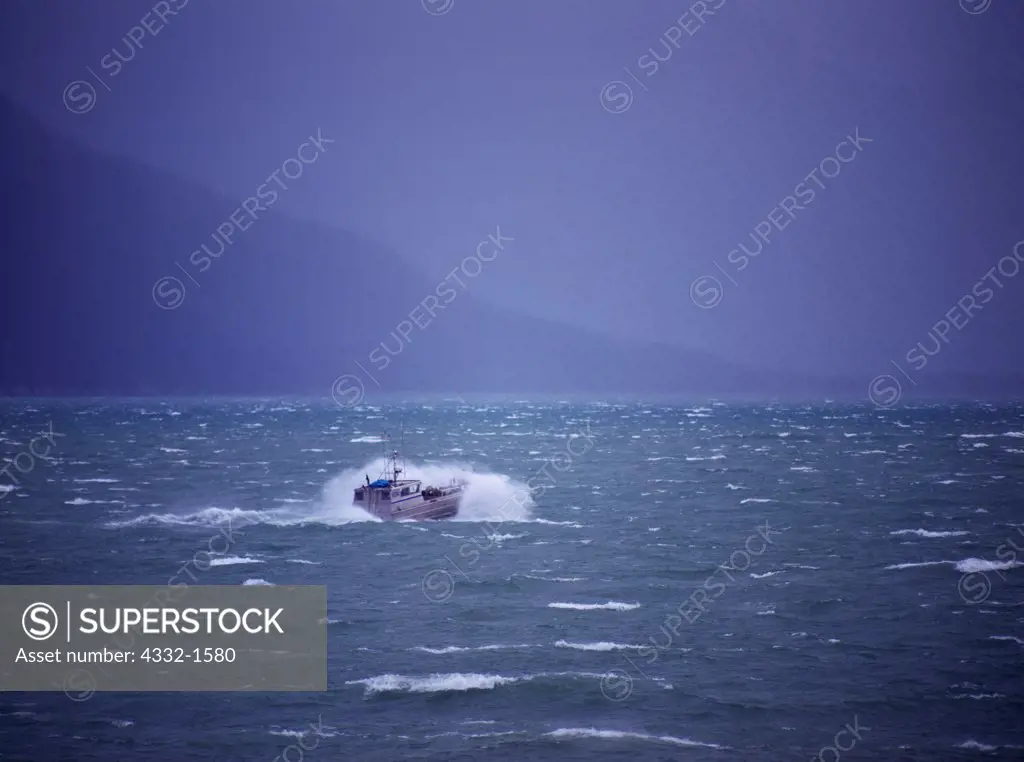 Fishing boat crashing into waves, storm conditions with whitecaps on Lutak Inlet at the northern end of Lynn Canal, Alaska.