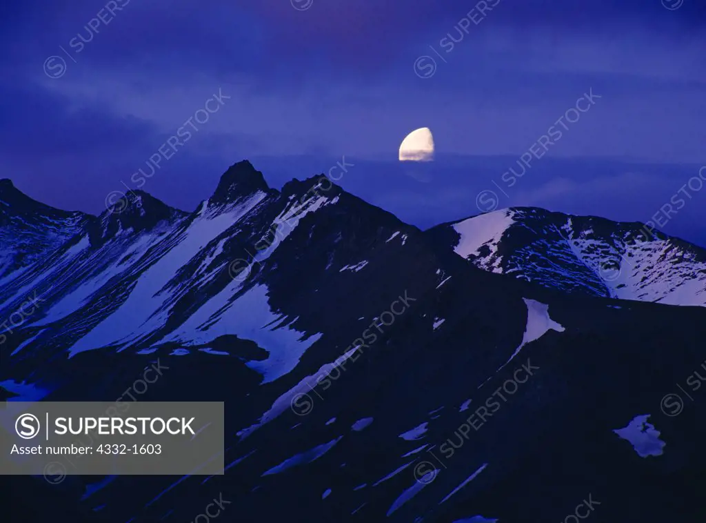 Gibbous moon rising at midnight over the Alaska Range east of Eielson, Denali National Park, Alaska.