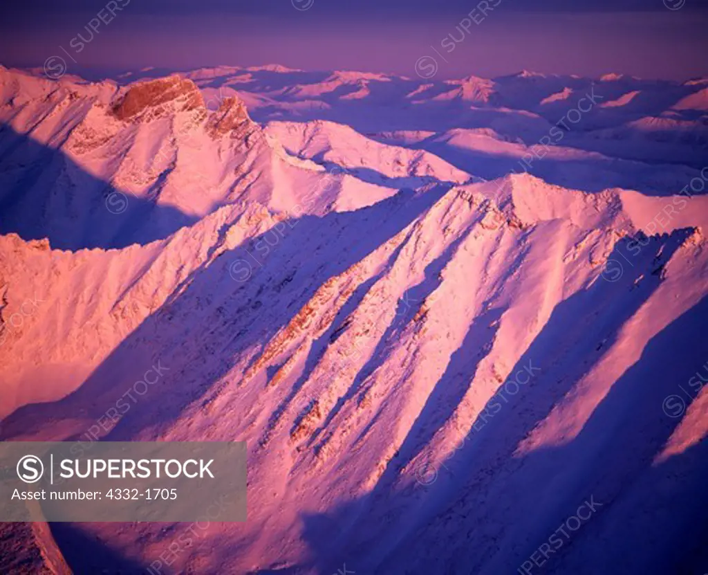 Aerial view of a winter sunrise illuminating the Arrigetch Peaks of the Brooks Range, Gates of the Arctic National Park, Alaska.