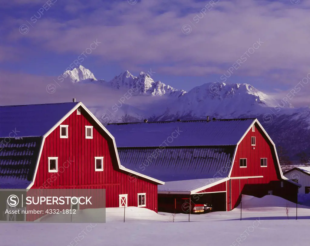 Twin barns of the Gislason Farm with Twin Peaks of the Chugach Mountains beyond, Matanuska Valley, Alaska.