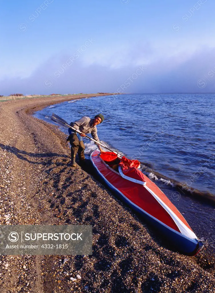 Fred Hirschmann with Folboat, east end of Krusenstern Lagoon, Cape Krusenstern National Monument, Alaska.