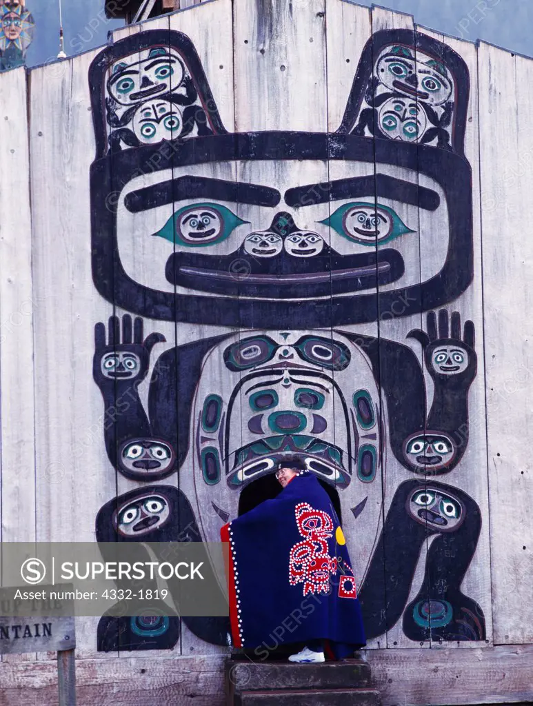 Tlingit elder Marge Byrd of the Kik.setti Clan in entrance to Chief Shakes Tribal House, Shakes Island, Wrangell, Alaska.  Button Blanket depicting Tlingit legend of Raven releasing the sun from a bentwood box.