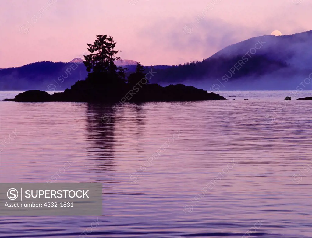Full moon setting over Sitka Sound on a misty morning, Baranof Island, Tongass National Forest, Alaska.