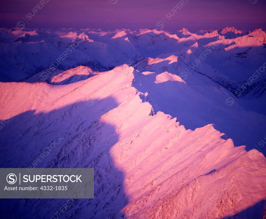 Aerial view of the first light of a winter sunrise illuminating the Brooks Range southeast of the Arrigetch Peaks, Gates of the Arctic National Park, Alaska.