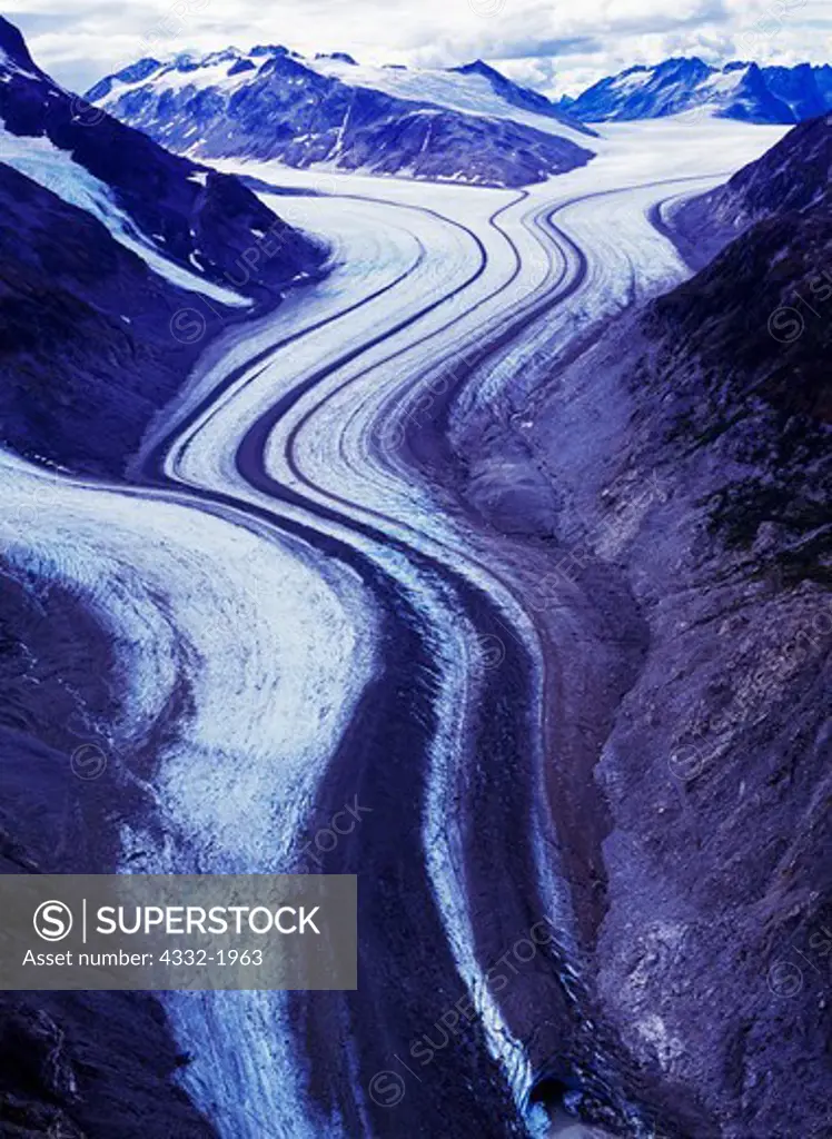 Medial moraines on valley glacier flowing from the Chigmit Mountains at the head of Tuxedni River, Lake Clark National Park, Alaska.