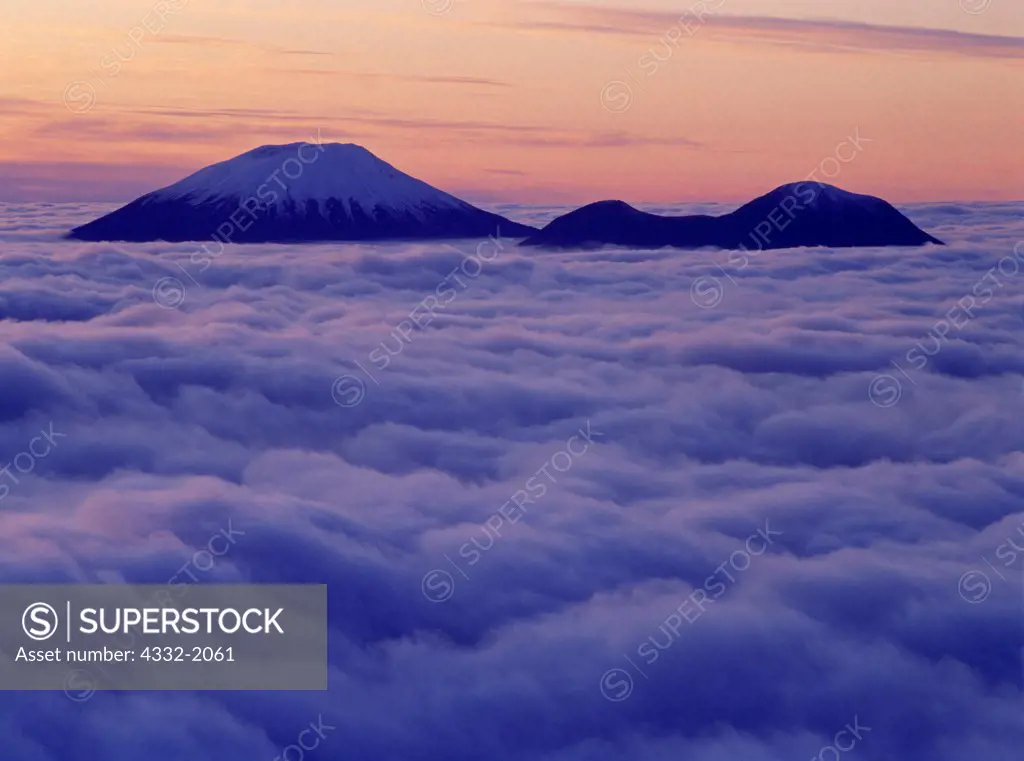 Volcanic cones of Mount Edgecumbe and Crater Ridge rising above fog covering Sitka Sound and the Gulf of Alaska, Tongass National Forest, Alaska.