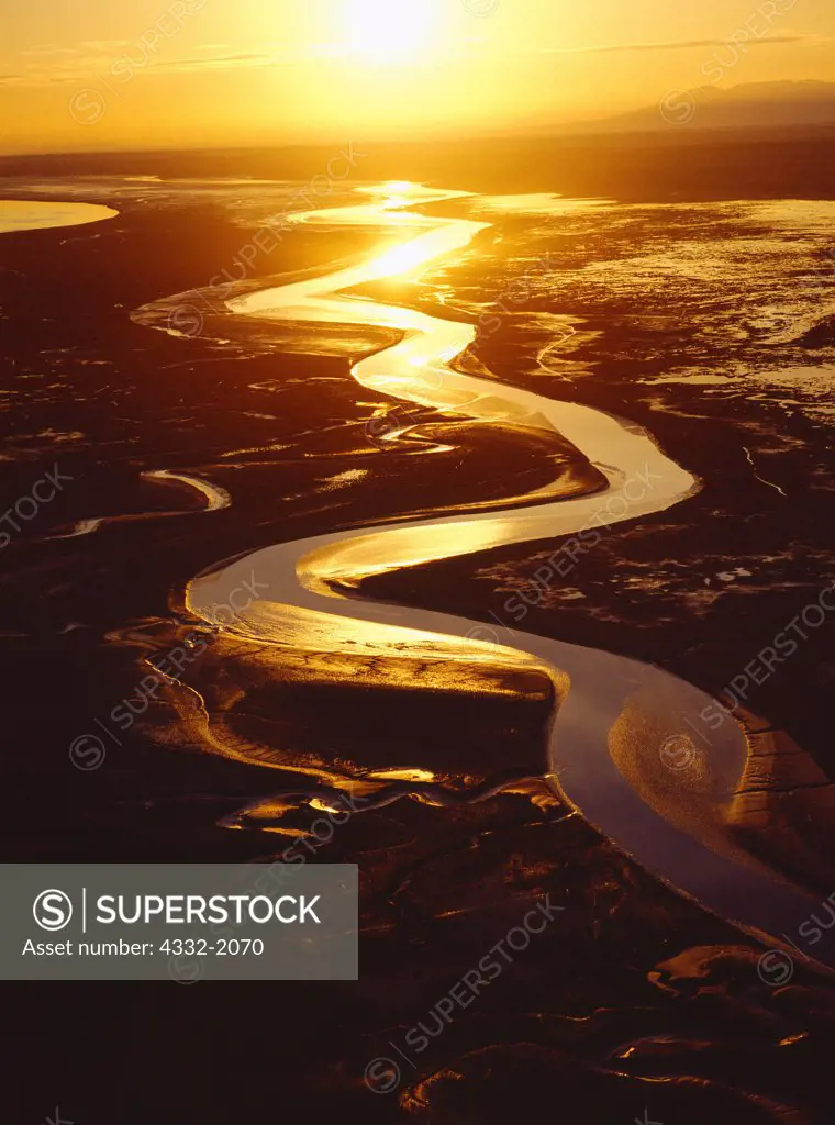 Aerial photo of sun setting over mudflats where the Matanuska and Knik Rivers drain into the Knik Arm of Cook Inlet, Alaska.