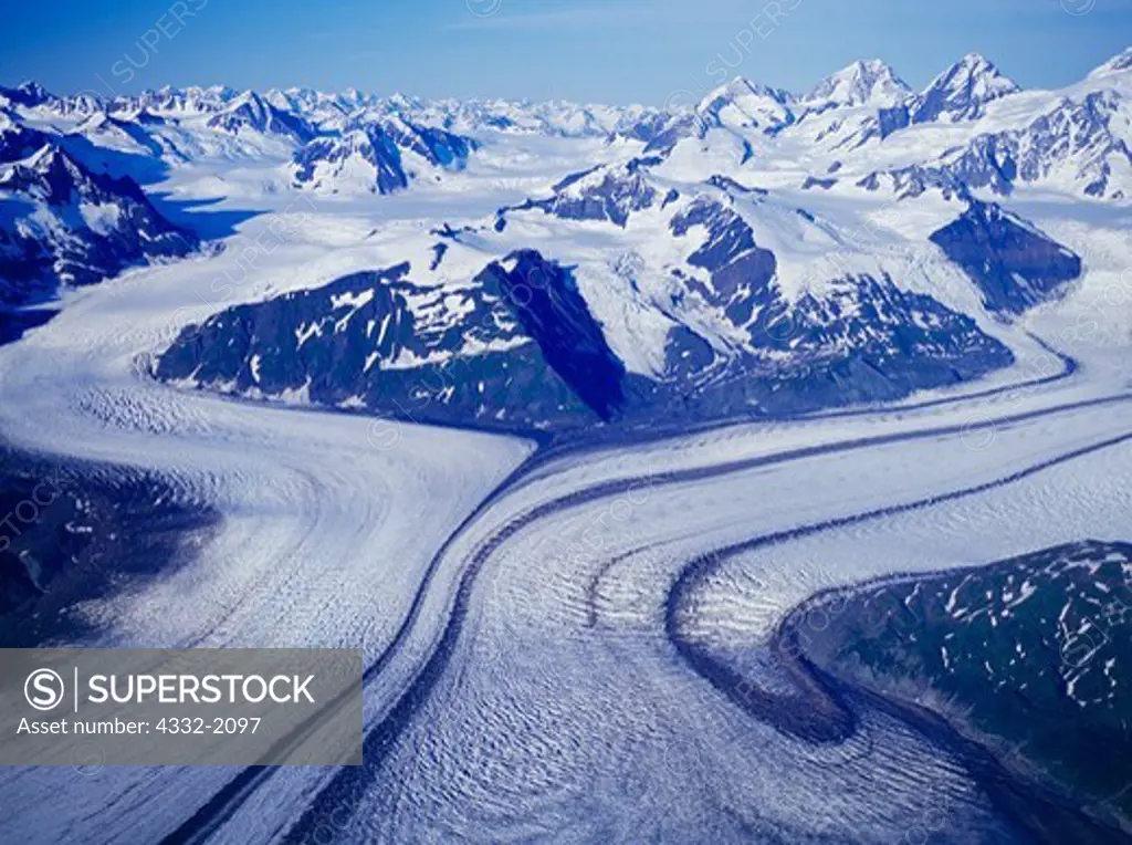 Aerial view of medial moraines on the Grand Plateau Glacier with peaks of the Saint Elias Mountains beyond, Glacier Bay National Park, Alaska.