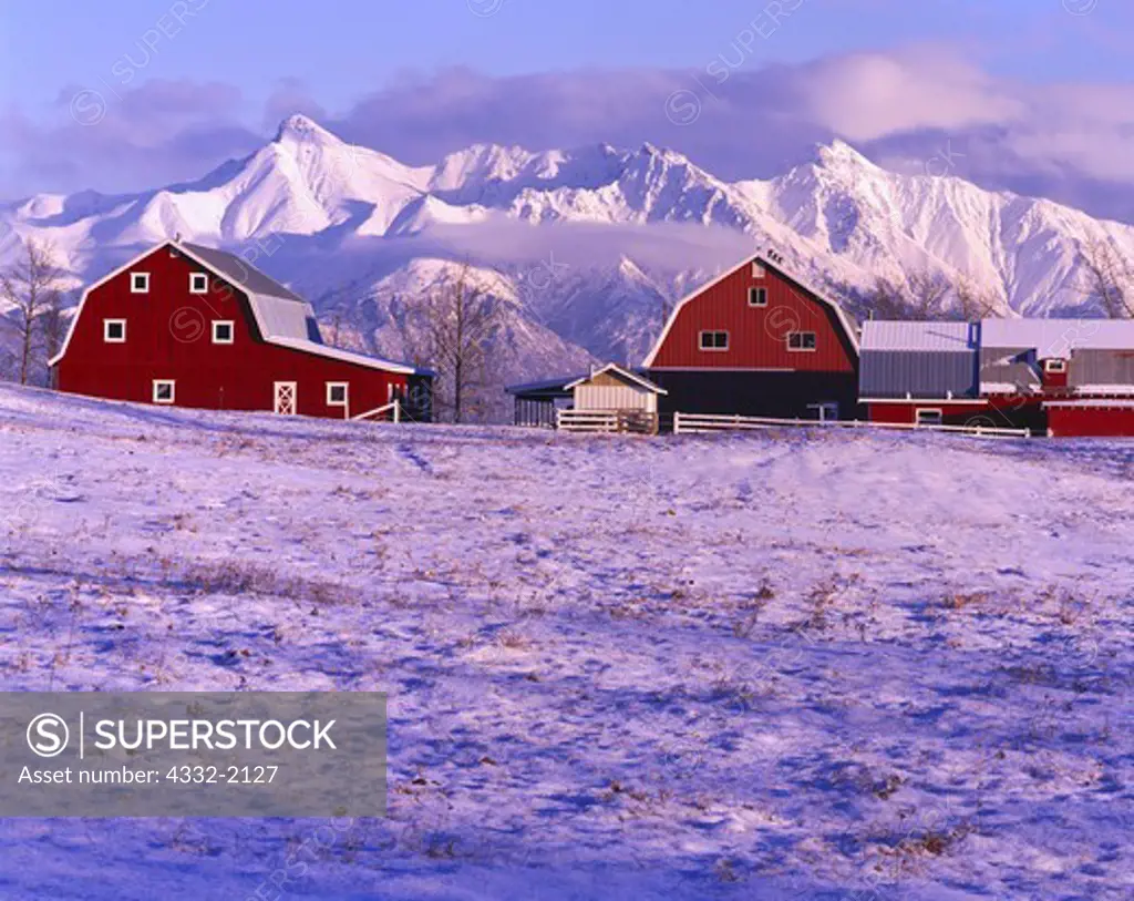 Winter view of the Gislason Farm with the Chugach Mountains rising beyond, Matanuska Valley, Alaska.