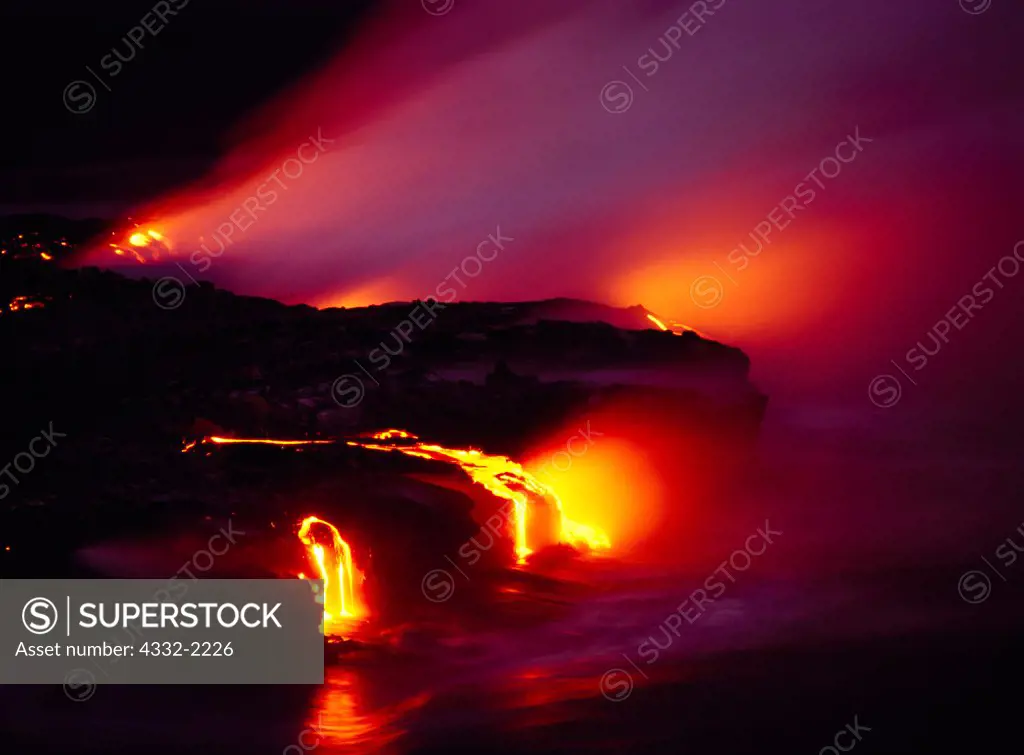 Steam rising off molten lava flowing into the sea, Pali Uli, Hawaii Volcanoes National Park, Big Island of Hawaii.