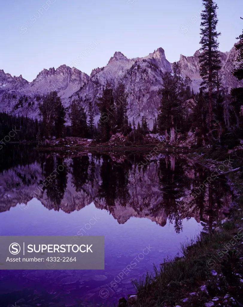 Dawn reflection of the Sawtooth Mountains in Alice Lake, Sawtooth Wilderness, Sawtooth National Forest, Idaho.